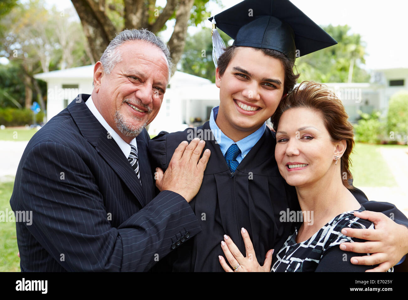 Hispanic Student And Parents Celebrate Graduation Stock Photo