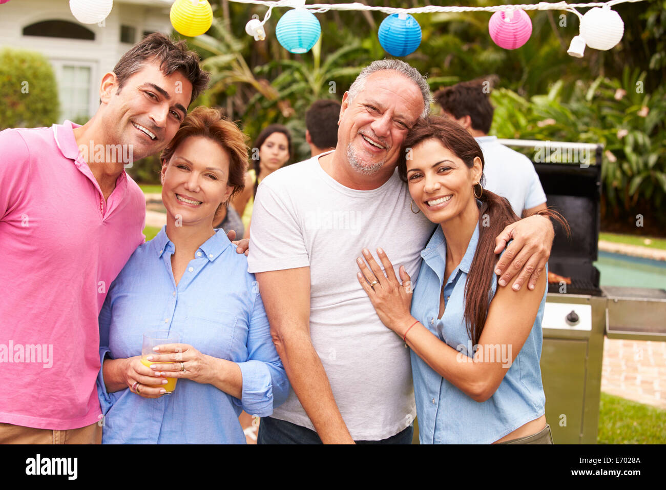 Parent With Adult Children Enjoying Party In Garden Stock Photo