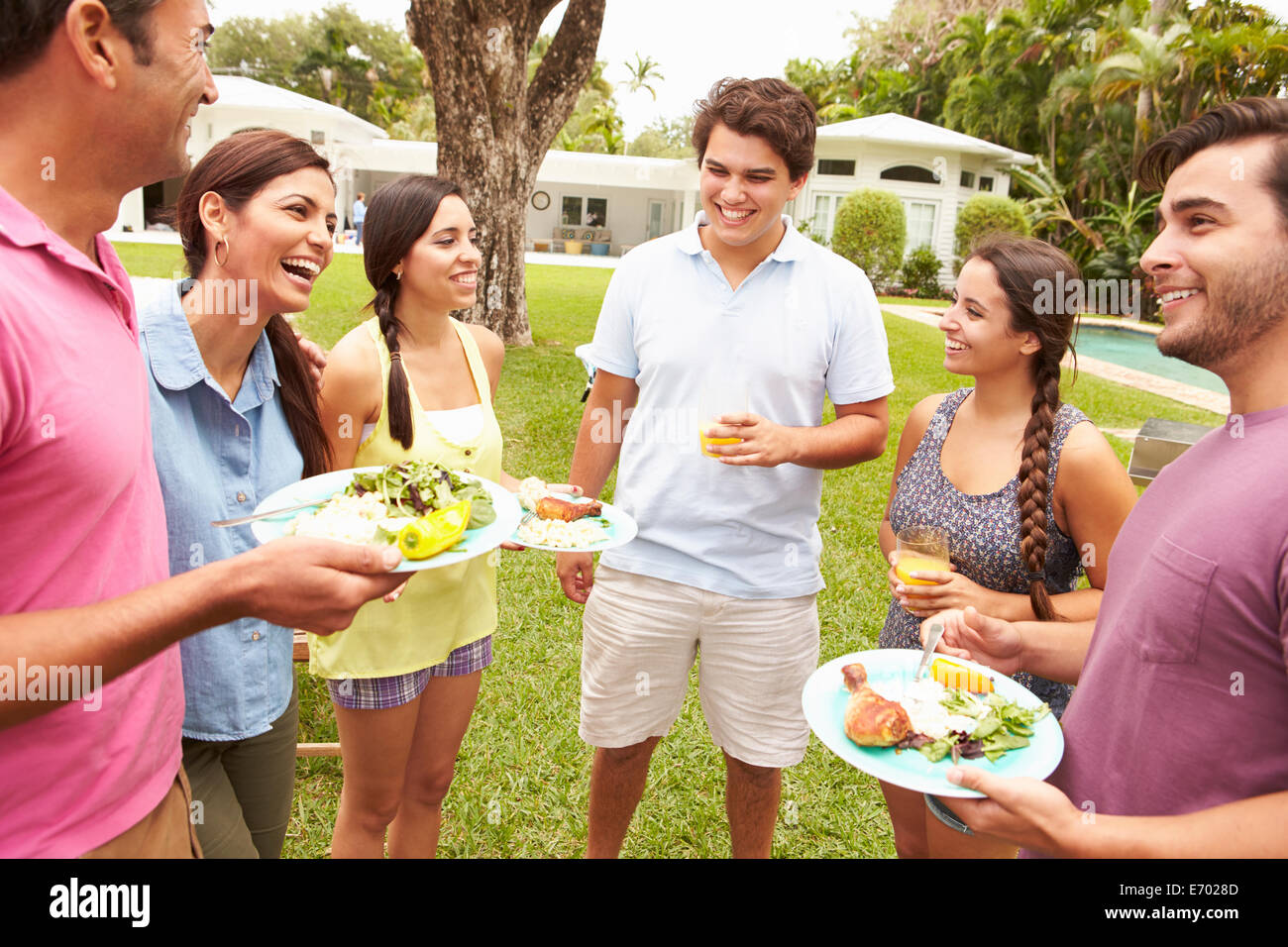 Group Of Friends Having Party In Backyard At Home Stock Photo