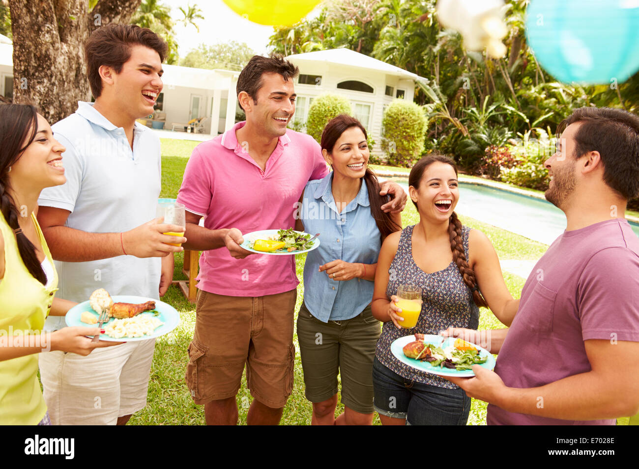 Group Of Friends Having Party In Backyard At Home Stock Photo