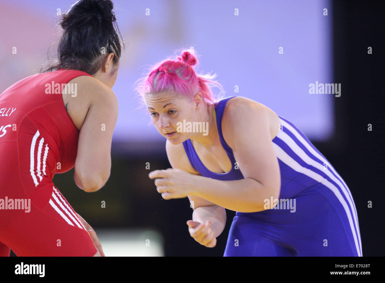 Stevie Kelly of Australia (red) v Sarah Connolly of Wales (blue) in the womens 63kg freestyle wrestling quarter finals. Stock Photo