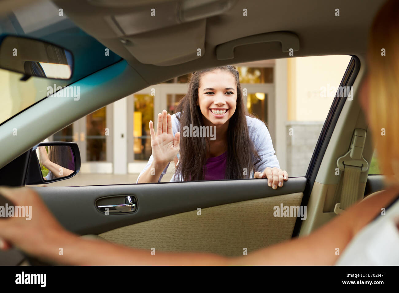 Female High School Student Being Dropped At School By Parent Stock Photo