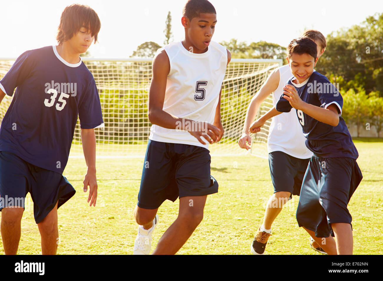 Members Of Male High School Soccer Playing Match Stock Photo