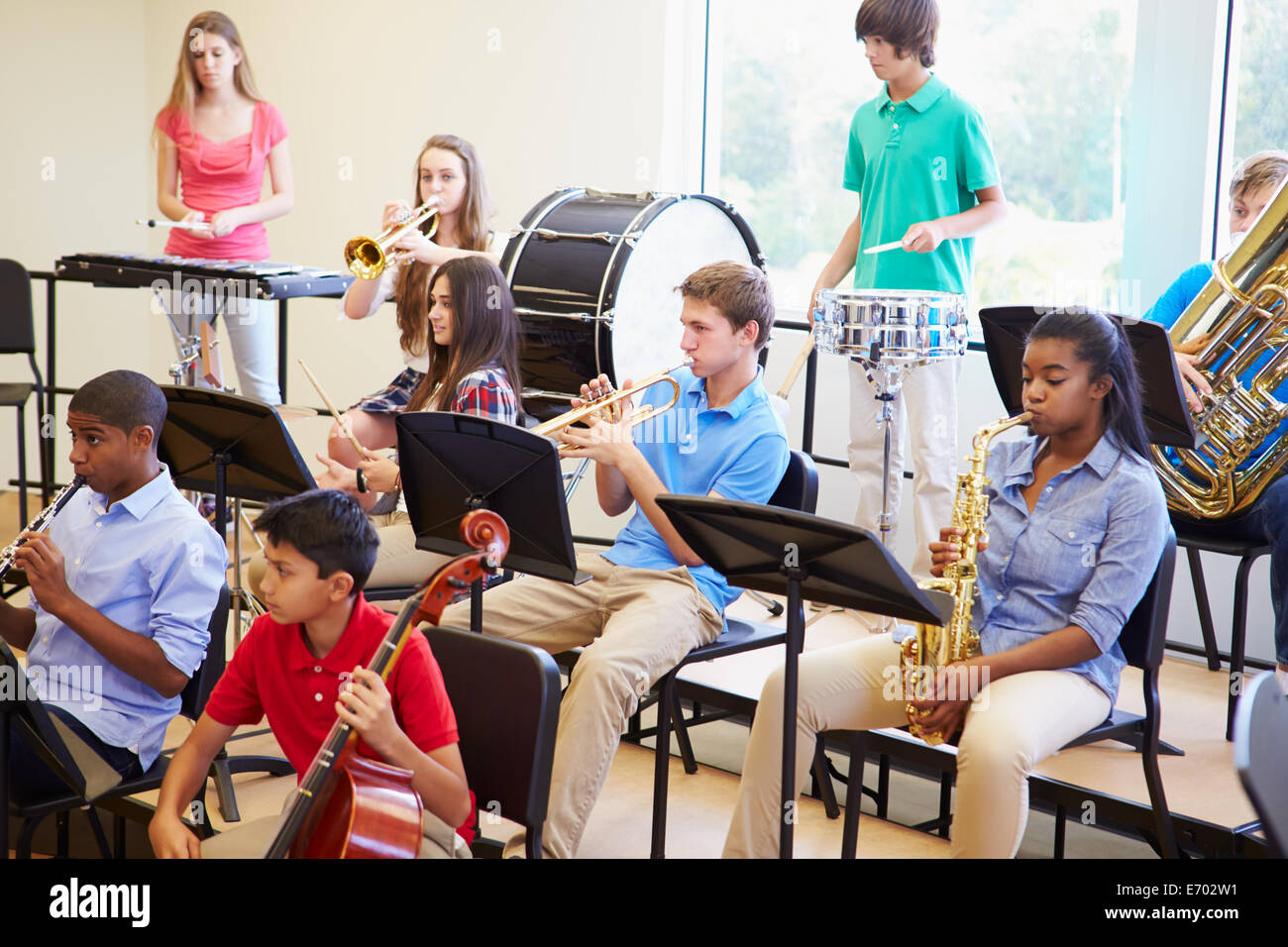 Pupils Playing Musical Instruments In School Orchestra Stock Photo