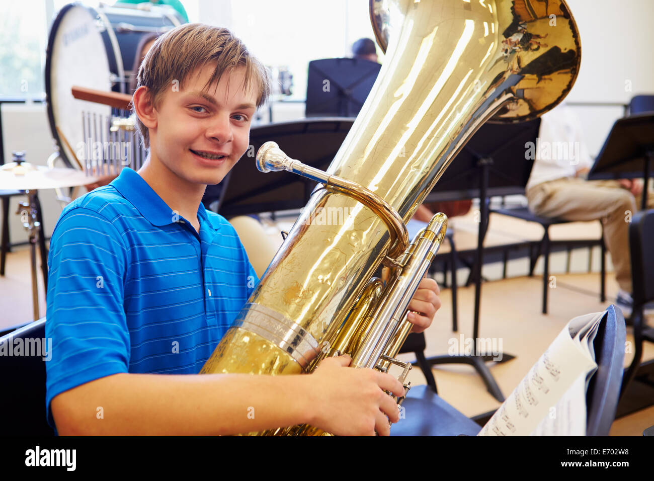 Male Pupil Playing Tuba In High School Orchestra Stock Photo