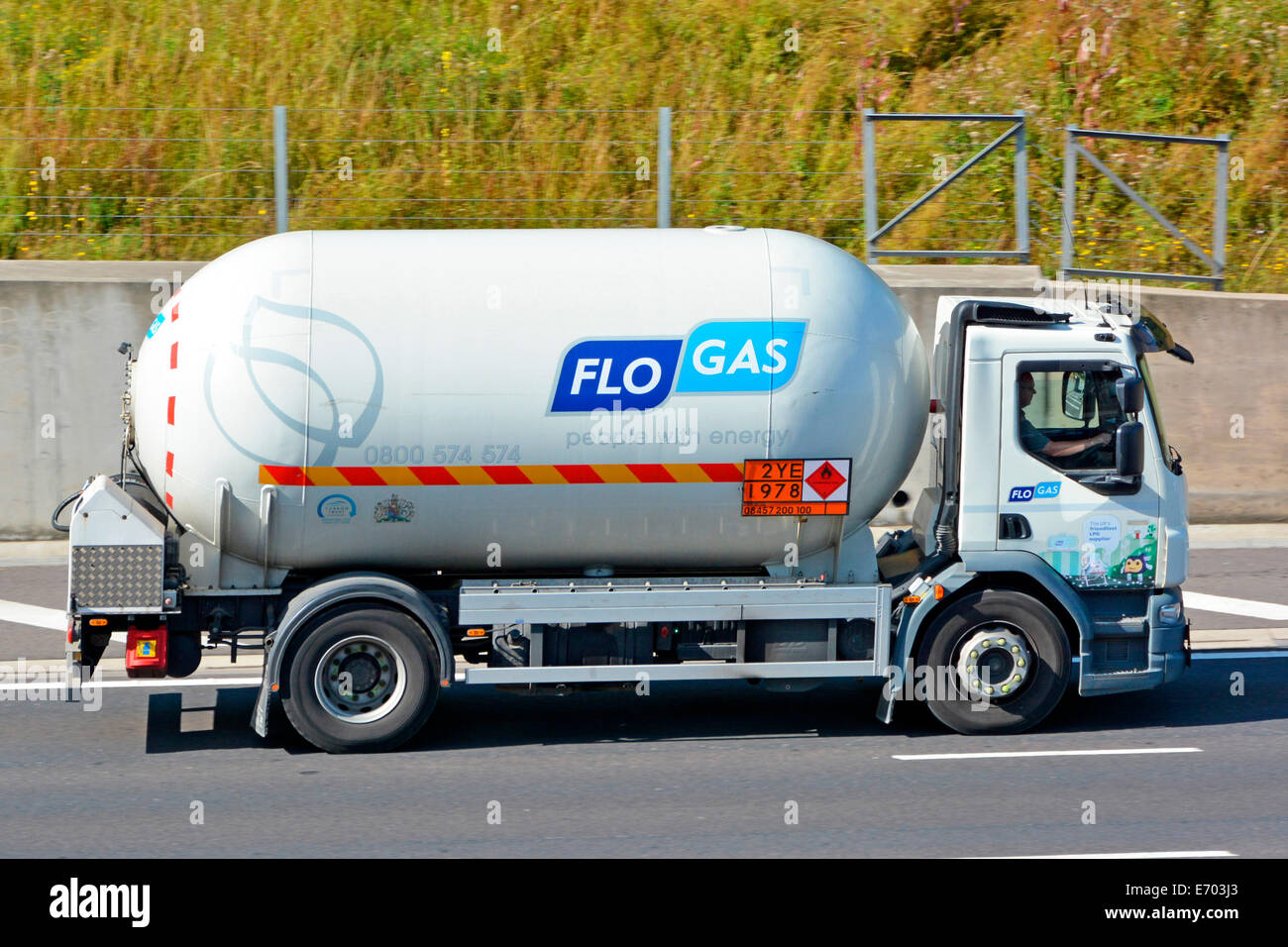 Short wheel base Flo Gas tanker lorry on motorway displaying Hazchem Hazardous Chemicals and Dangerous Goods information sign England UK Stock Photo