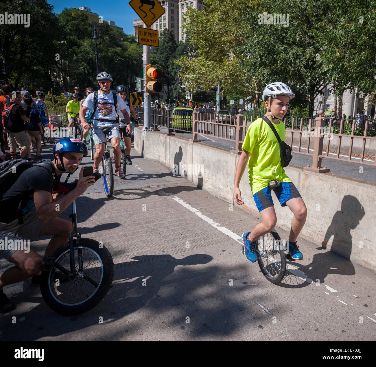 A young unicyclist rides across the Brooklyn Bridge during 13mile trip to Coney Island Stock