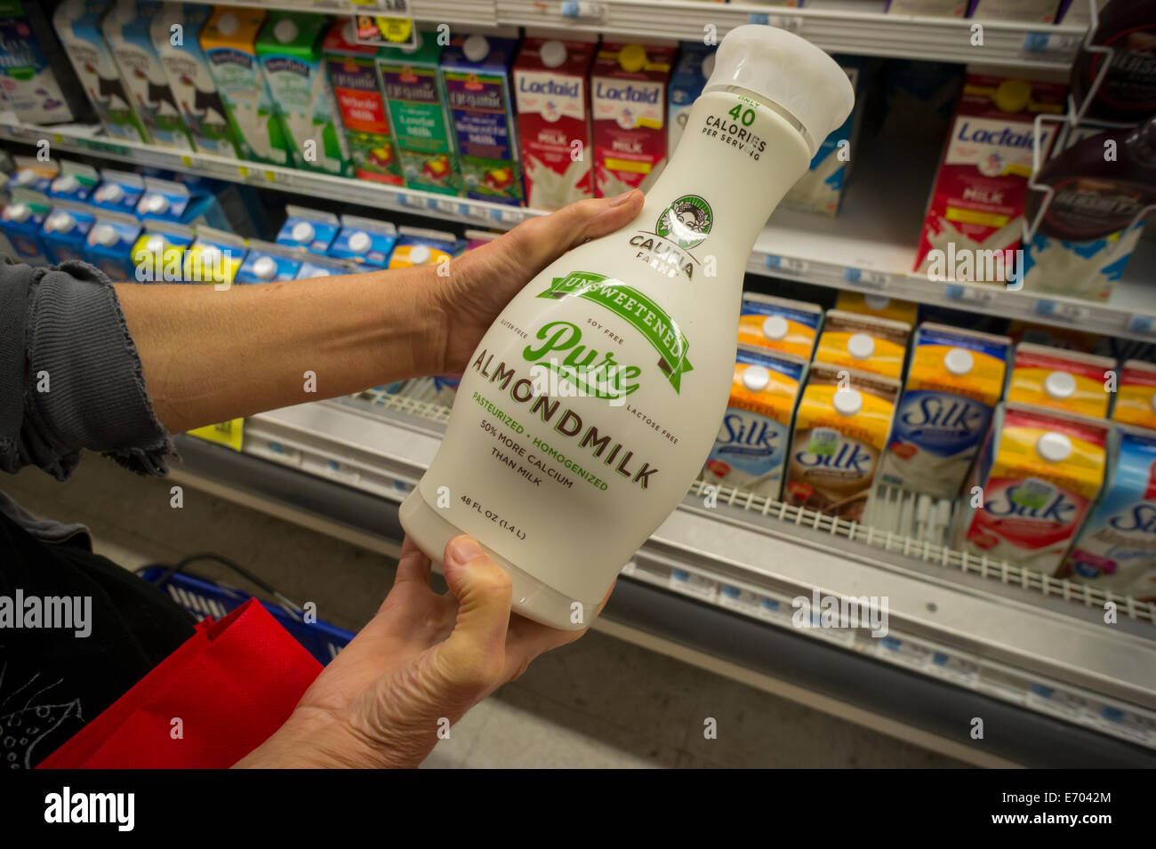 A customer chooses Califia brand almond milk in a supermarket in New York Stock Photo