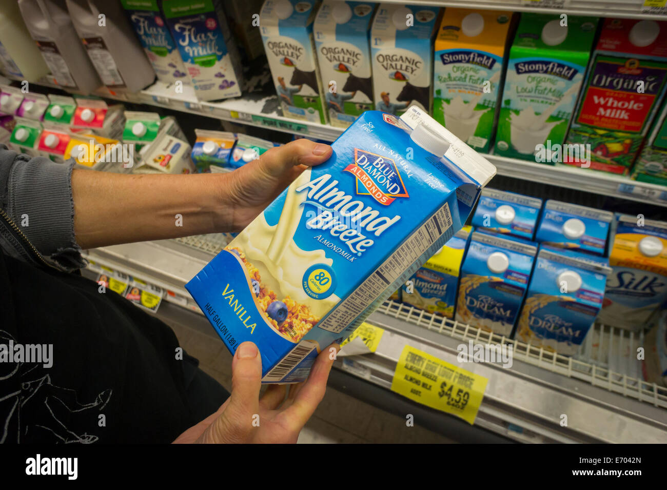 A customer chooses Blue Diamond brand almond milk in a supermarket in New York Stock Photo