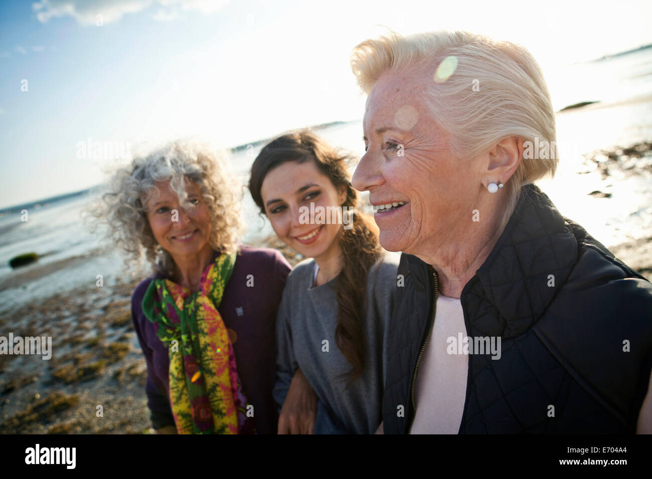 Female family members chatting on beach Stock Photo