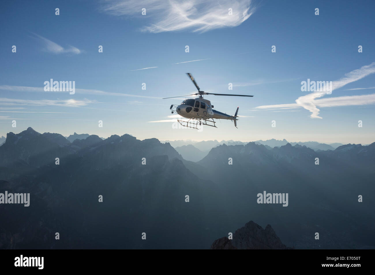 Helicopter on scenic flight at sunrise, Alleghe, Dolomites, Italy Stock Photo