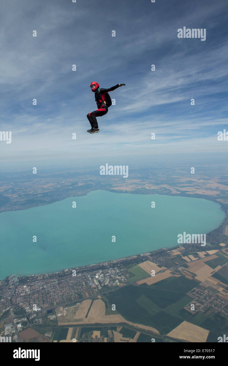 Female skydiver free falling above Siofok, Somogy, Hungary Stock Photo