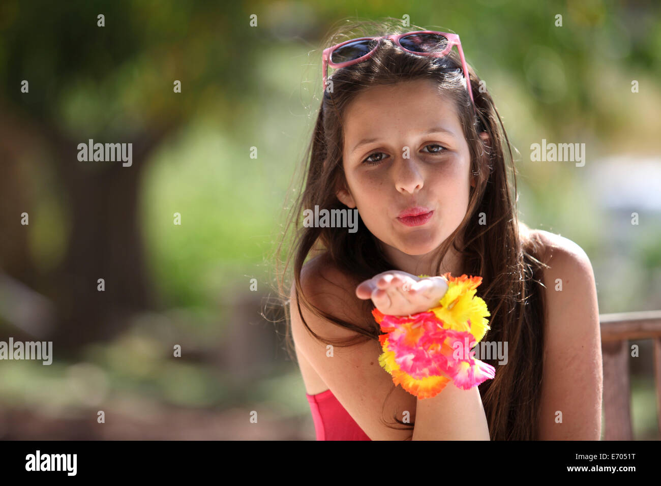 Portrait of a girl in park blowing a kiss Stock Photo