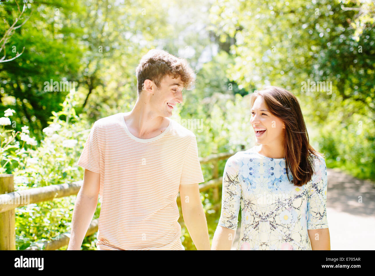 Couple walking in the park Stock Photo - Alamy