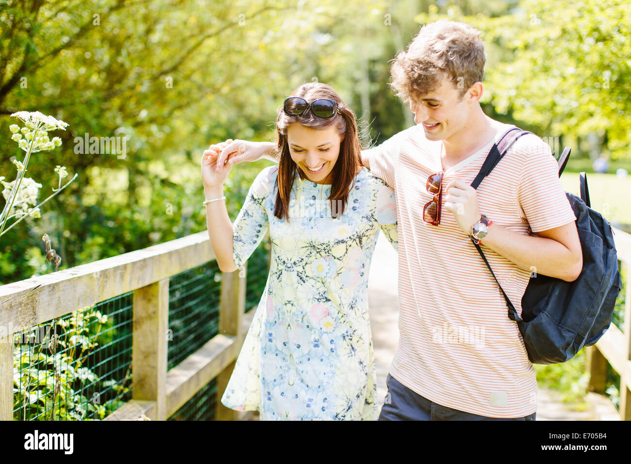 Couple walking over wooden bridge in the park Stock Photo