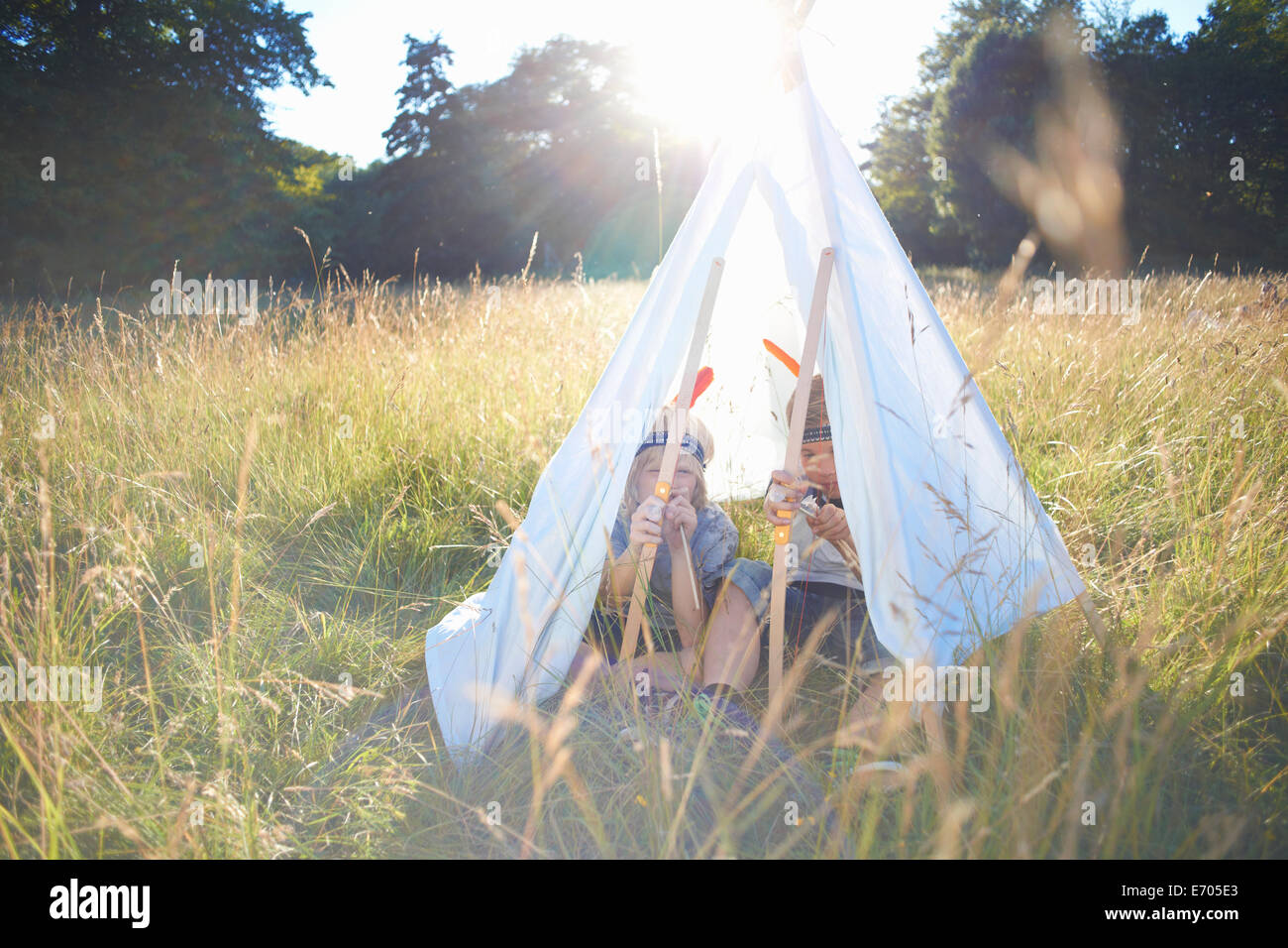 Two young boys sitting inside a teepee Stock Photo