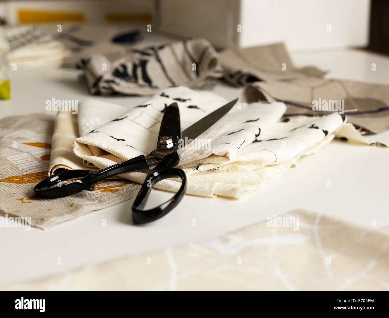 Pair of scissors and fabric on work table Stock Photo