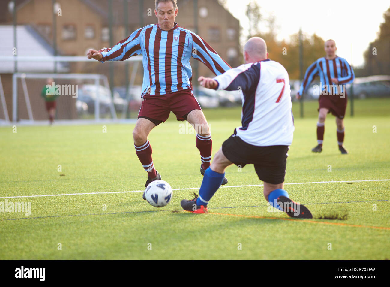 Football players fighting for ball Stock Photo