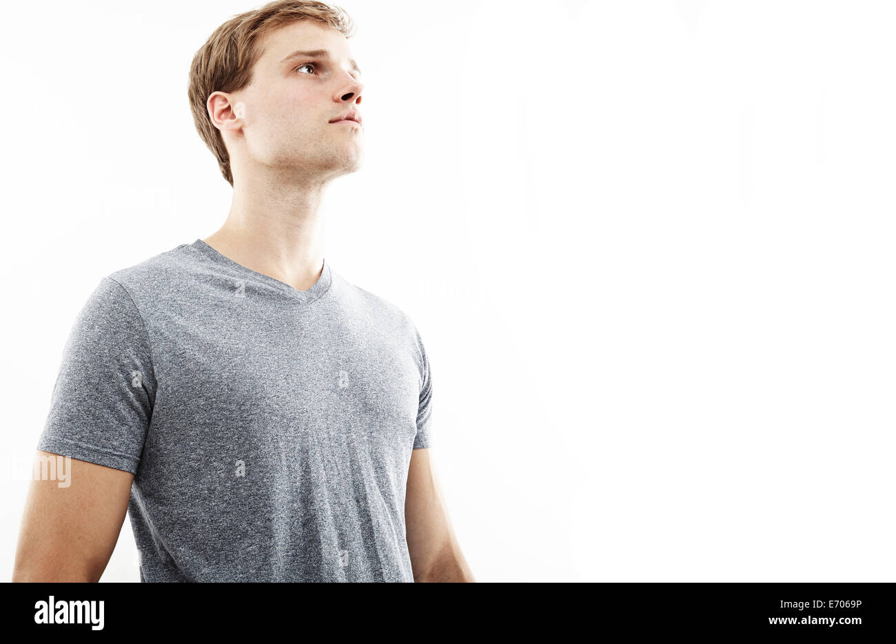 Studio portrait of young man gazing upward Stock Photo