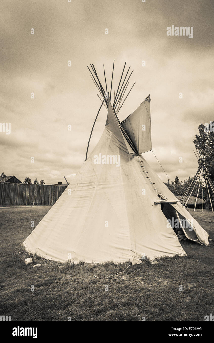 A tepee (tipi, teepee) is a Plains Indian home. It is made of buffalo hide fastened around very long wooden poles, designed in a Stock Photo