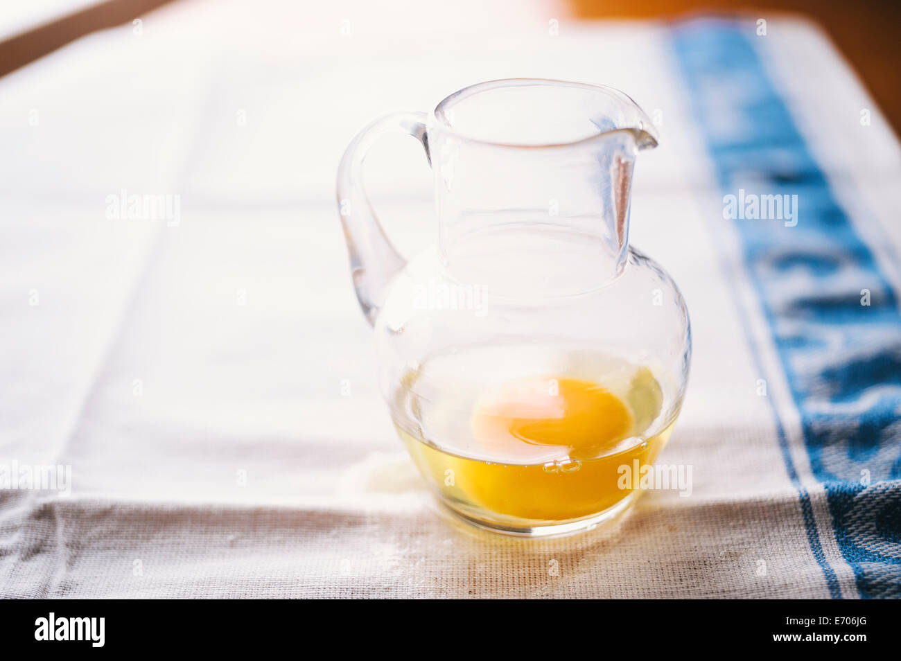 Raw egg in glass jug Stock Photo Alamy