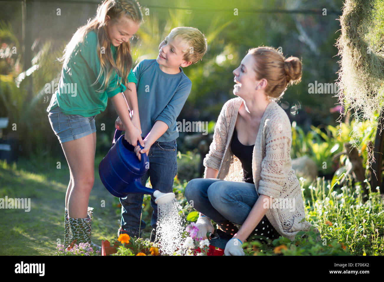Girl and boy watering plants hi-res stock photography and images - Alamy