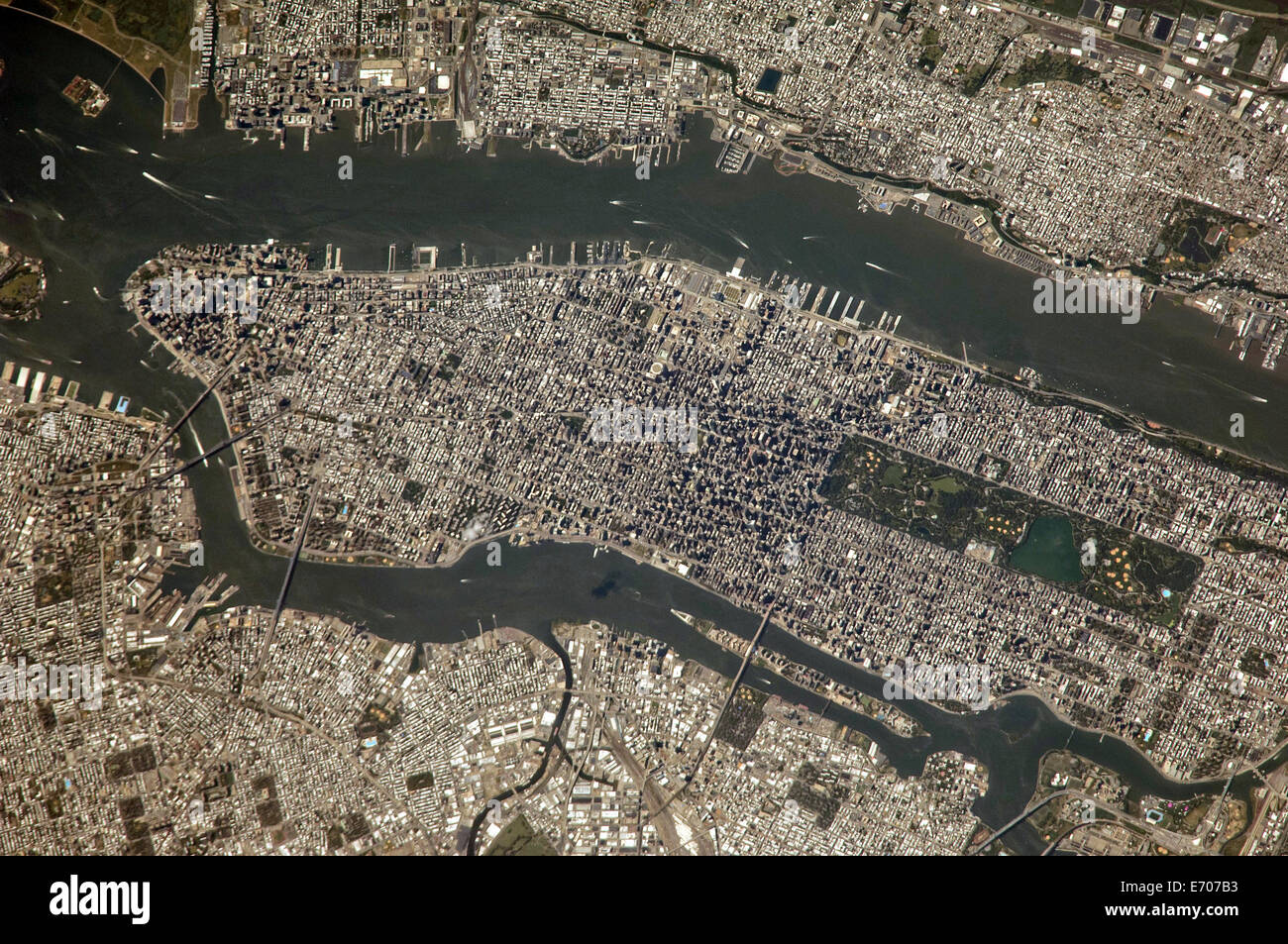 View from the International Space Station of New York City revealing the narrow shape of Manhattan located between the Hudson River and the East River August 25, 2014. Manhattan Island and its Central Park are tell-tale points for recognition purposes for the six-person crew of the orbital outpost, flying approximately 225 nautical miles above the city. The 800mm focal length used by the crew member provides great detail in the scene. Stock Photo