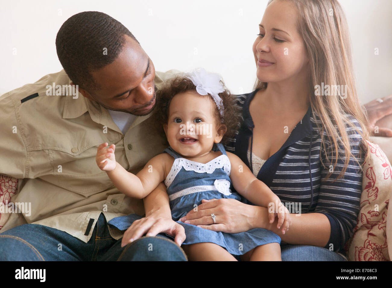 Mother and father holding baby daughter Stock Photo