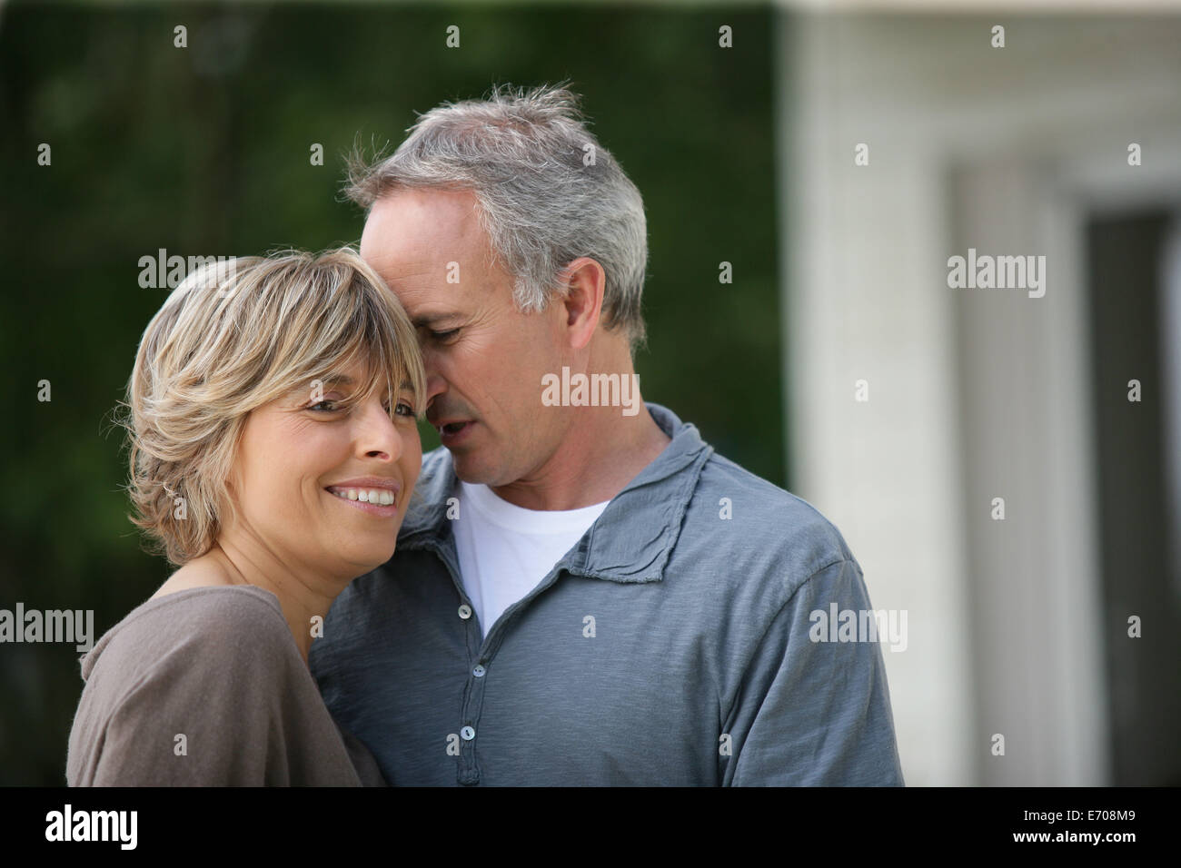 Married couple stood outside their house Stock Photo - Alamy