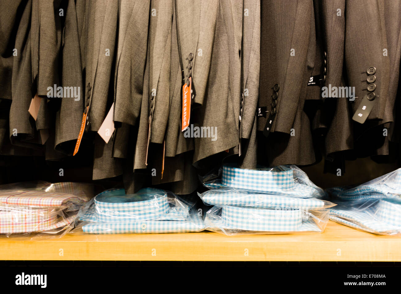 Row of sale suit jackets in men's clothes shop Stock Photo