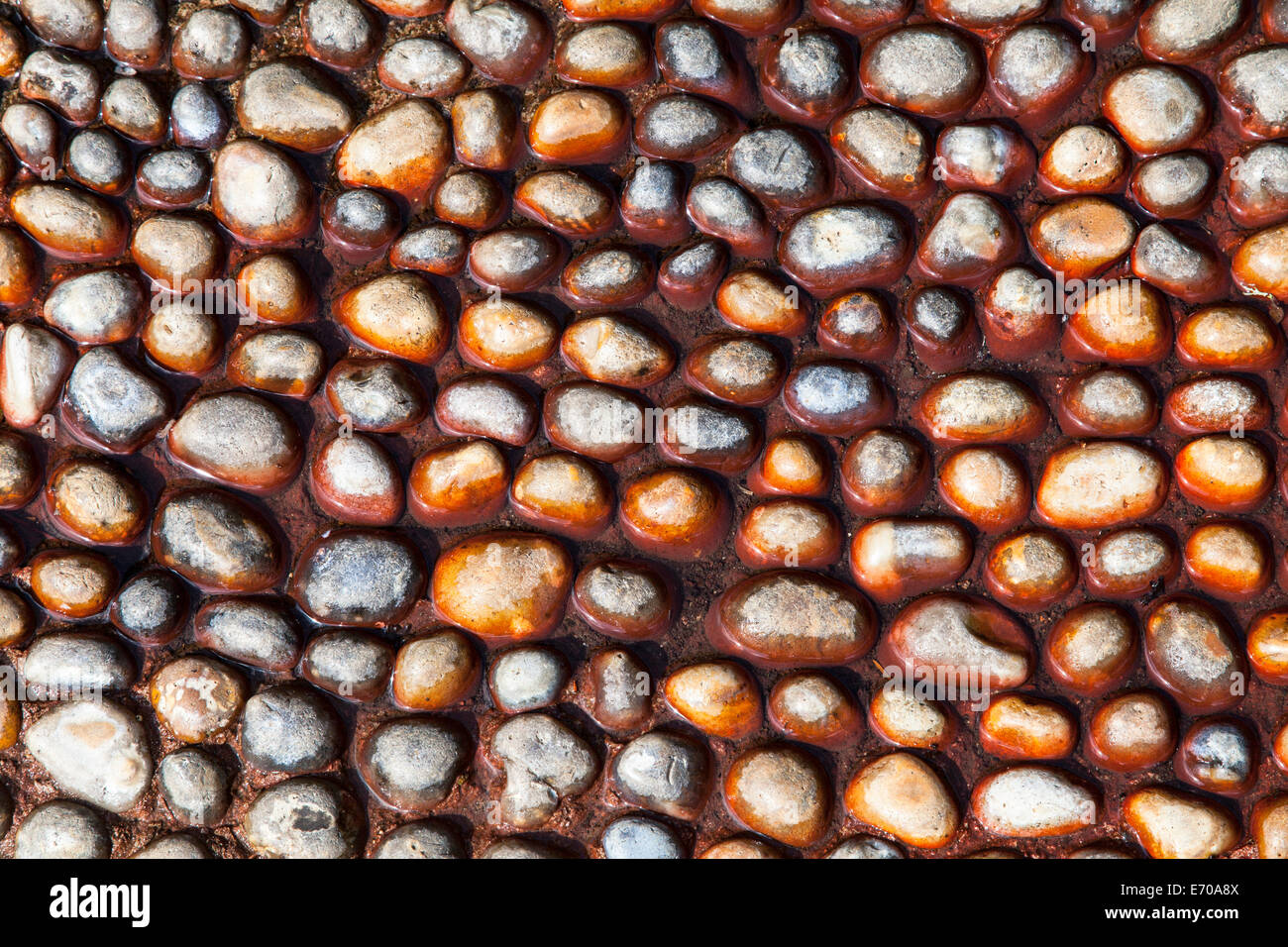 Pebble stones set in concrete Stock Photo