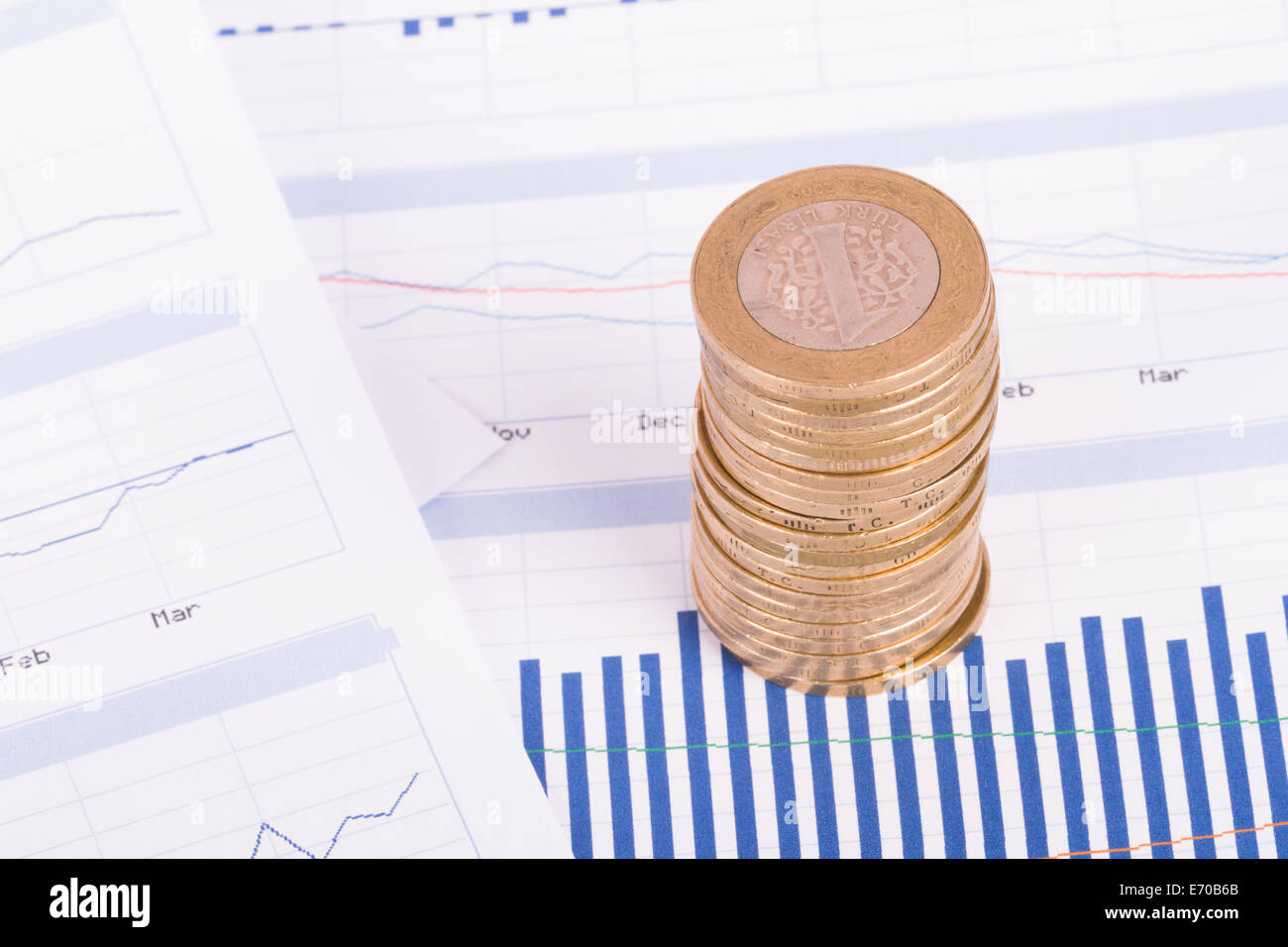 Coins on chart graphs and financial data analysis Stock Photo - Alamy