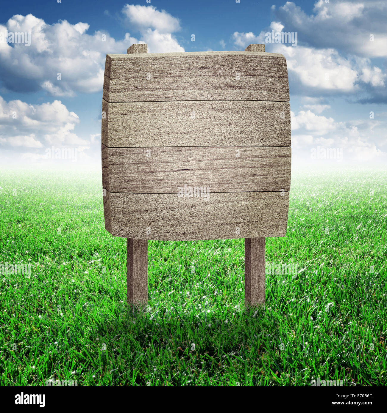 Road sign in green grass field over blue sky background Stock Photo - Alamy