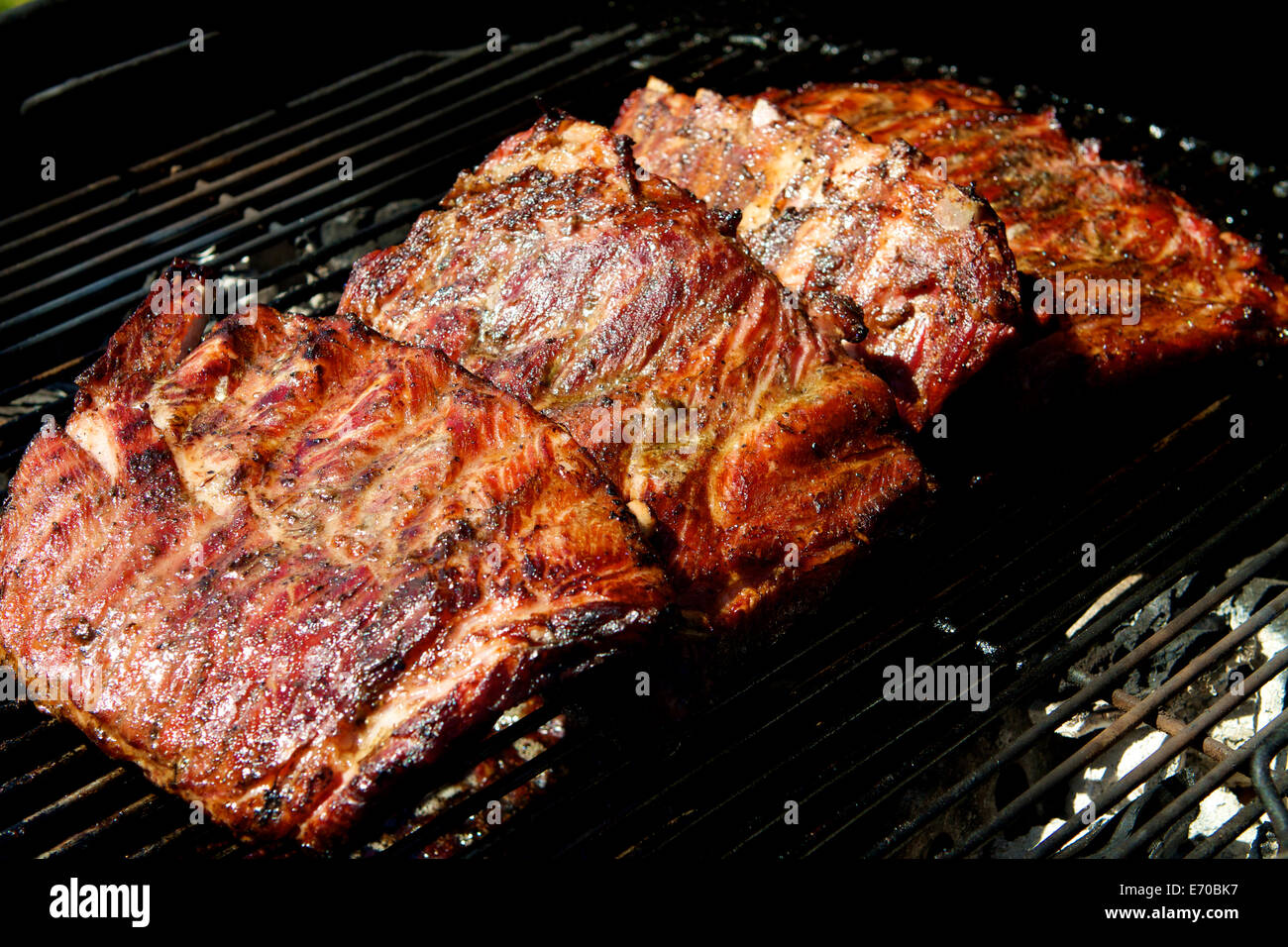 Barbecued  rack of   pork ribs outside in a garden Stock Photo