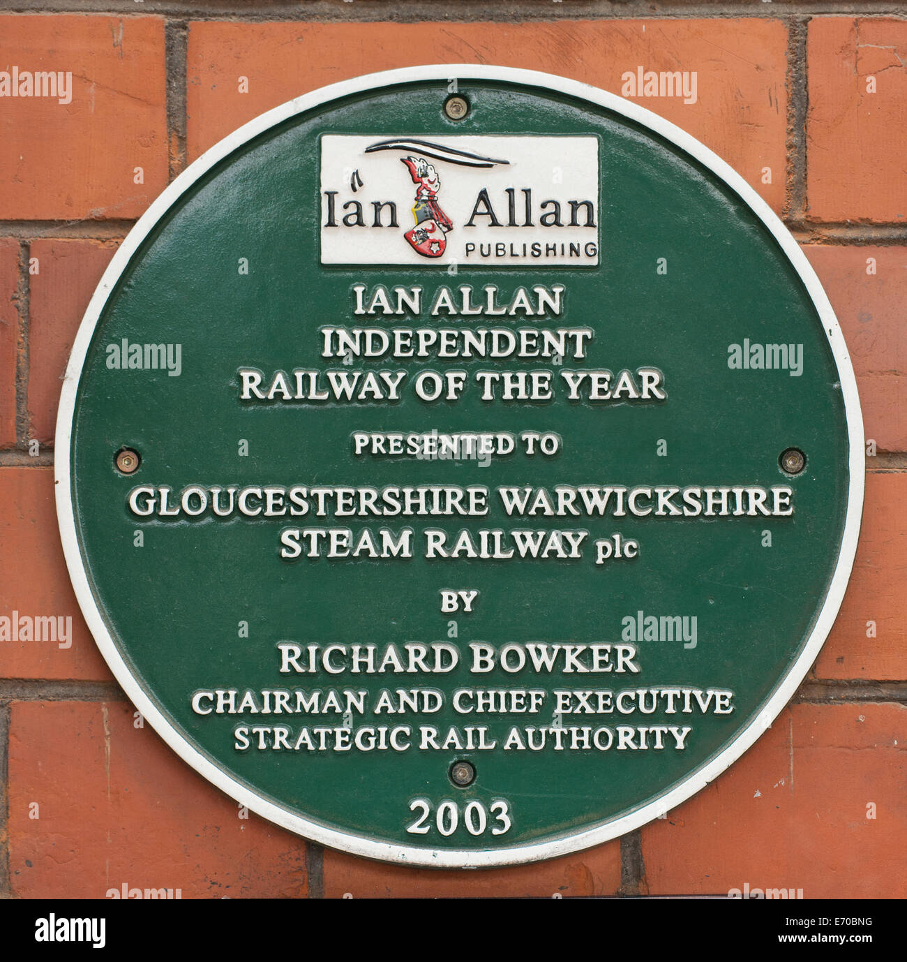 Green plaque awarded to Gloucestershire Warwickshire Steam Railway, at Teddington Railway Station, Gloucestershire, England, UK. Stock Photo