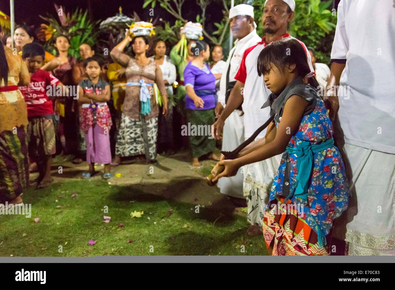 Pemuteran, Bali, Indonesia. 2nd Aug, 2013. Indonesian families participate int he Dewayu Trance Dance in remote North West Bali. Participants fly into a wild trance before taking a Kris (Traditional Dagger) to their chests. The power of the Hindu Gods is thought to protect those involved from injury. Children as young as 6 are encouraged to participate. © Brook Mitchell/ZUMA Wire/ZUMAPRESS.com/Alamy Live News Stock Photo