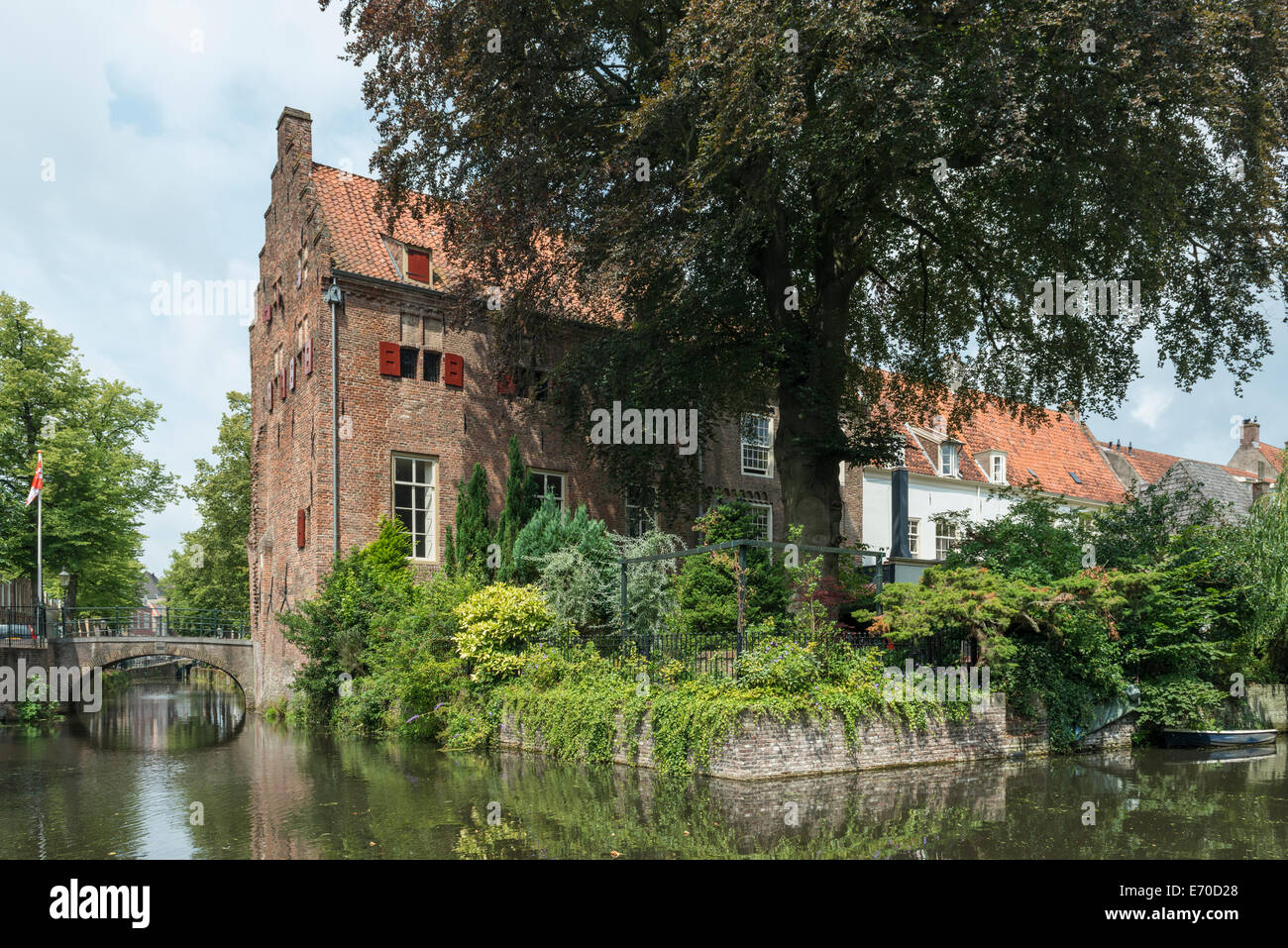 Historical house with tall tree at a canal (Gracht) in Amersfoort, Netherlands Stock Photo