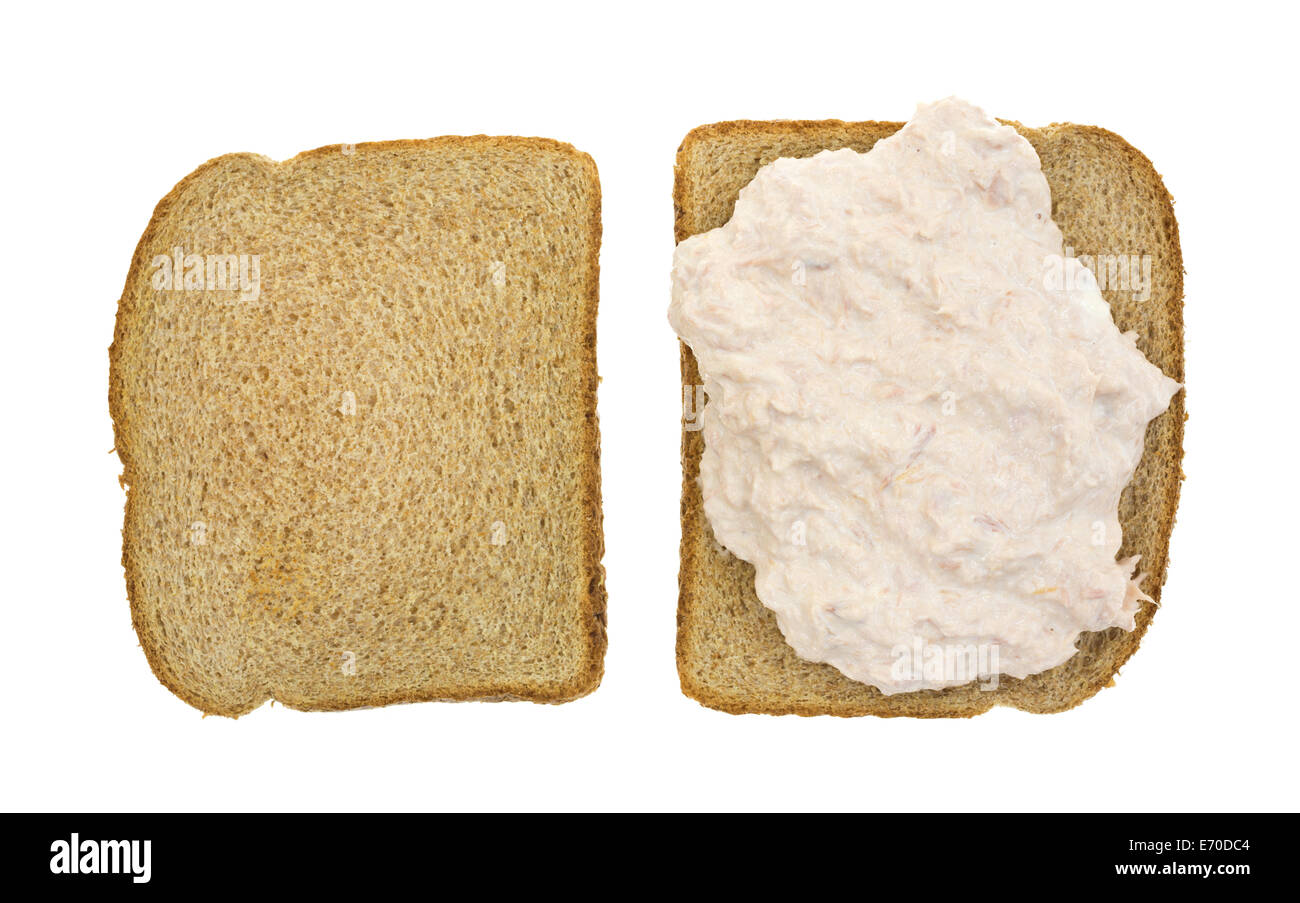 Top view of an open faced tuna sandwich on whole wheat bread atop a white background Stock Photo