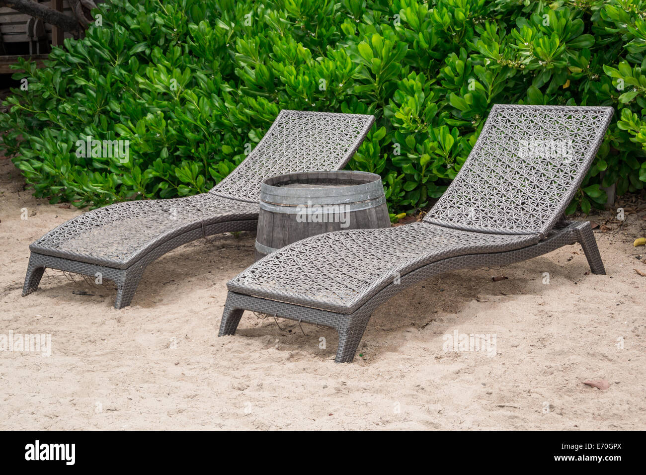 A pair of beach chairs and whiskey barrel table provide the perfect spot to catch some rays at