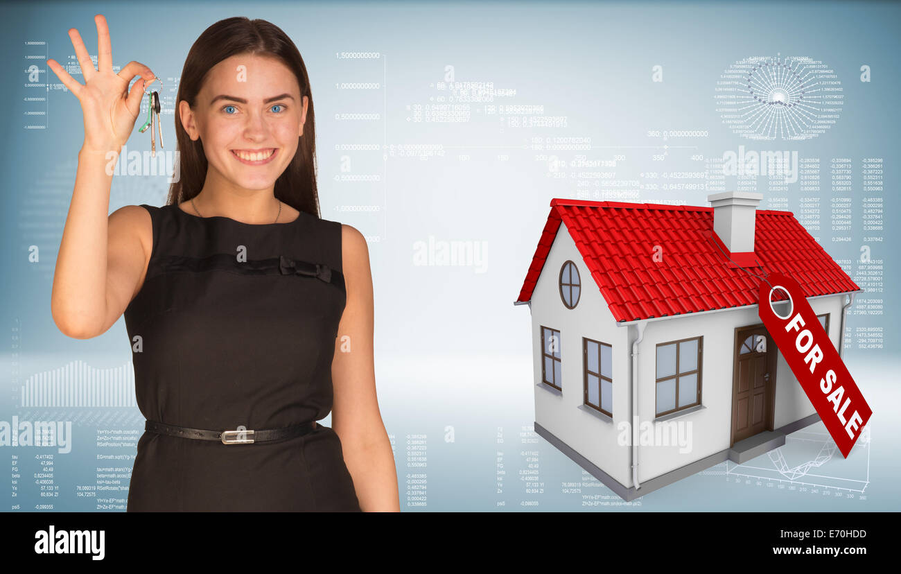 Beautiful woman with keys and small house Stock Photo - Alamy