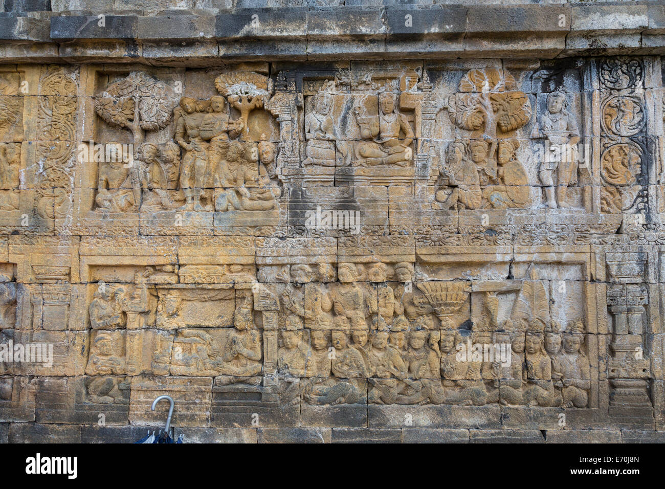 Borobudur, Java, Indonesia.  Bas-relief Stone Carving Showing Scenes from the Life of the Buddha. Stock Photo