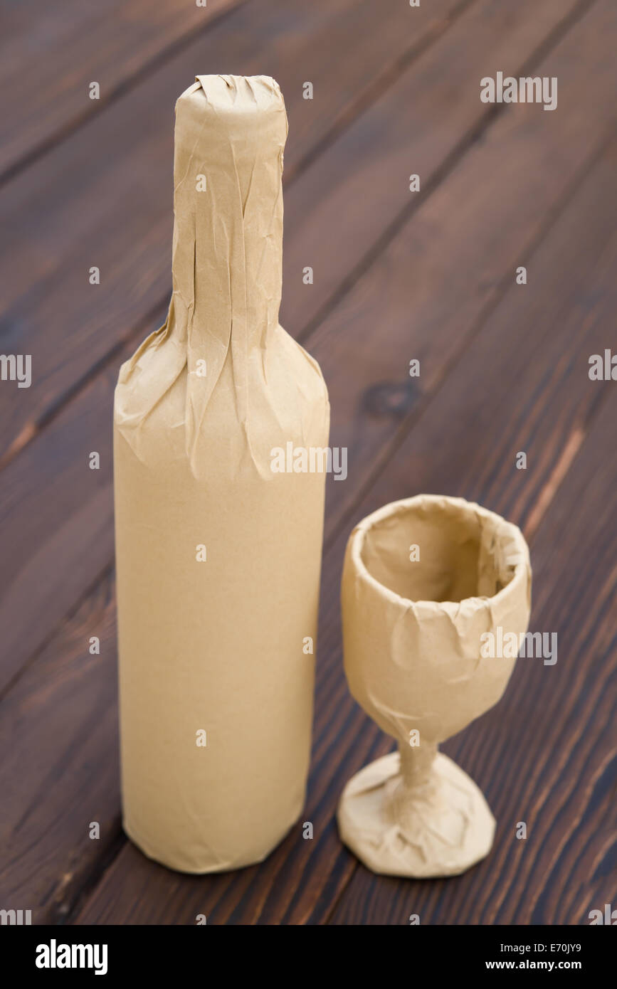 wine and cup wrapped up on wood background Stock Photo