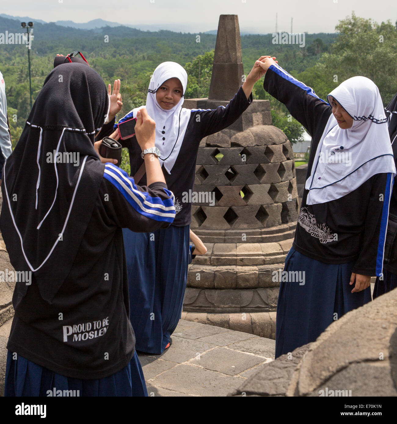 Borobudur, Java, Indonesia.  Young Indonesian Women Visiting the Temple.  'Proud to be Moslem' Written on their Clothing. Stock Photo