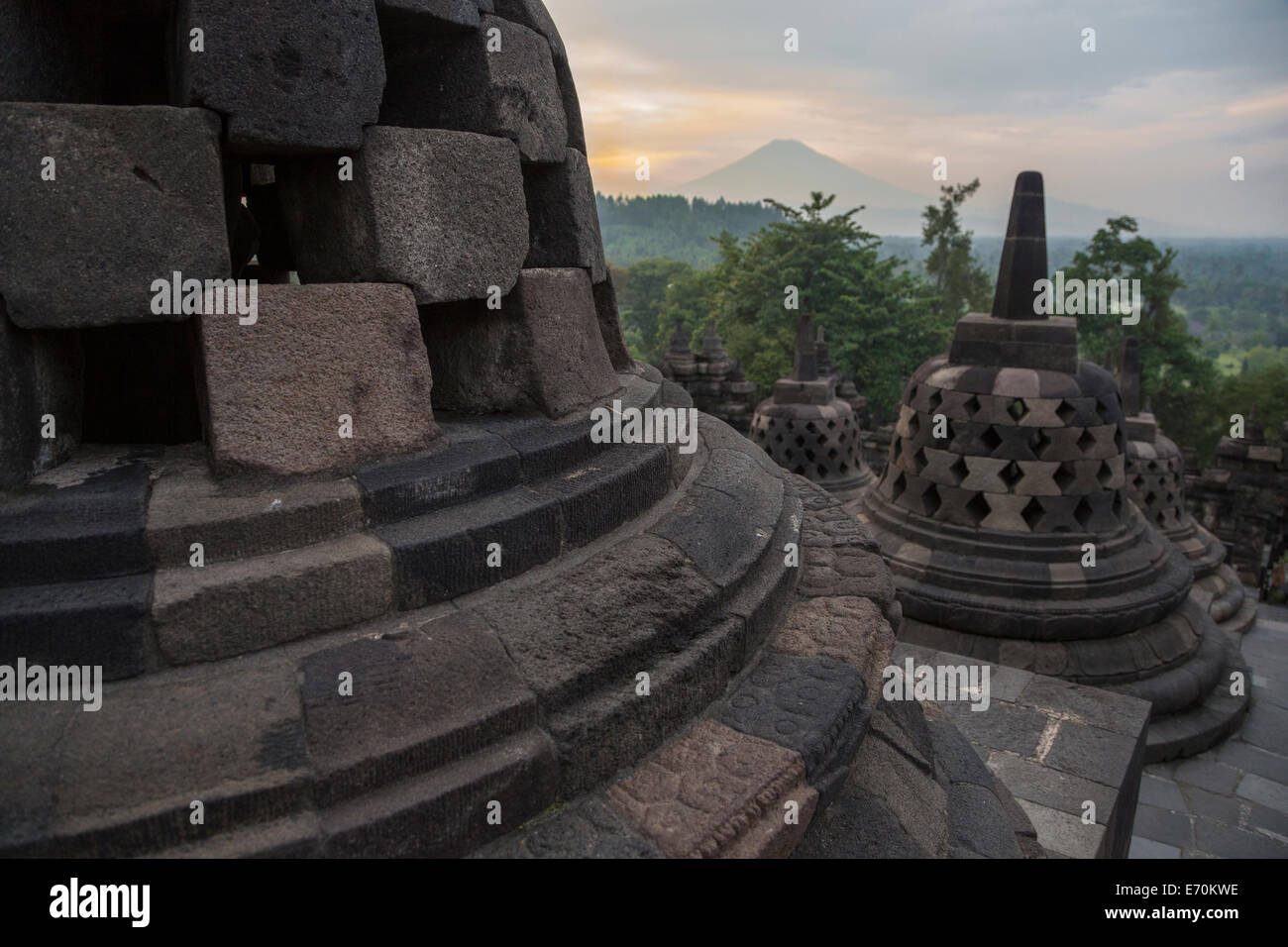 Borobudur, Java, Indonesia.  Stupas and Mount Merapi in Early-morning Haze. Stock Photo