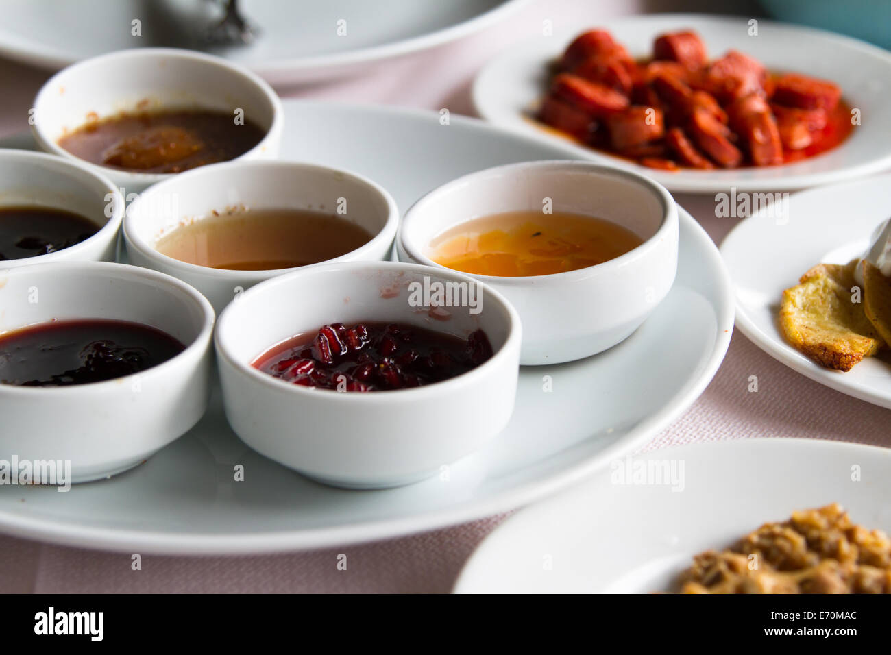 Breakfast service, jam and honey in white bowls on table Stock Photo ...