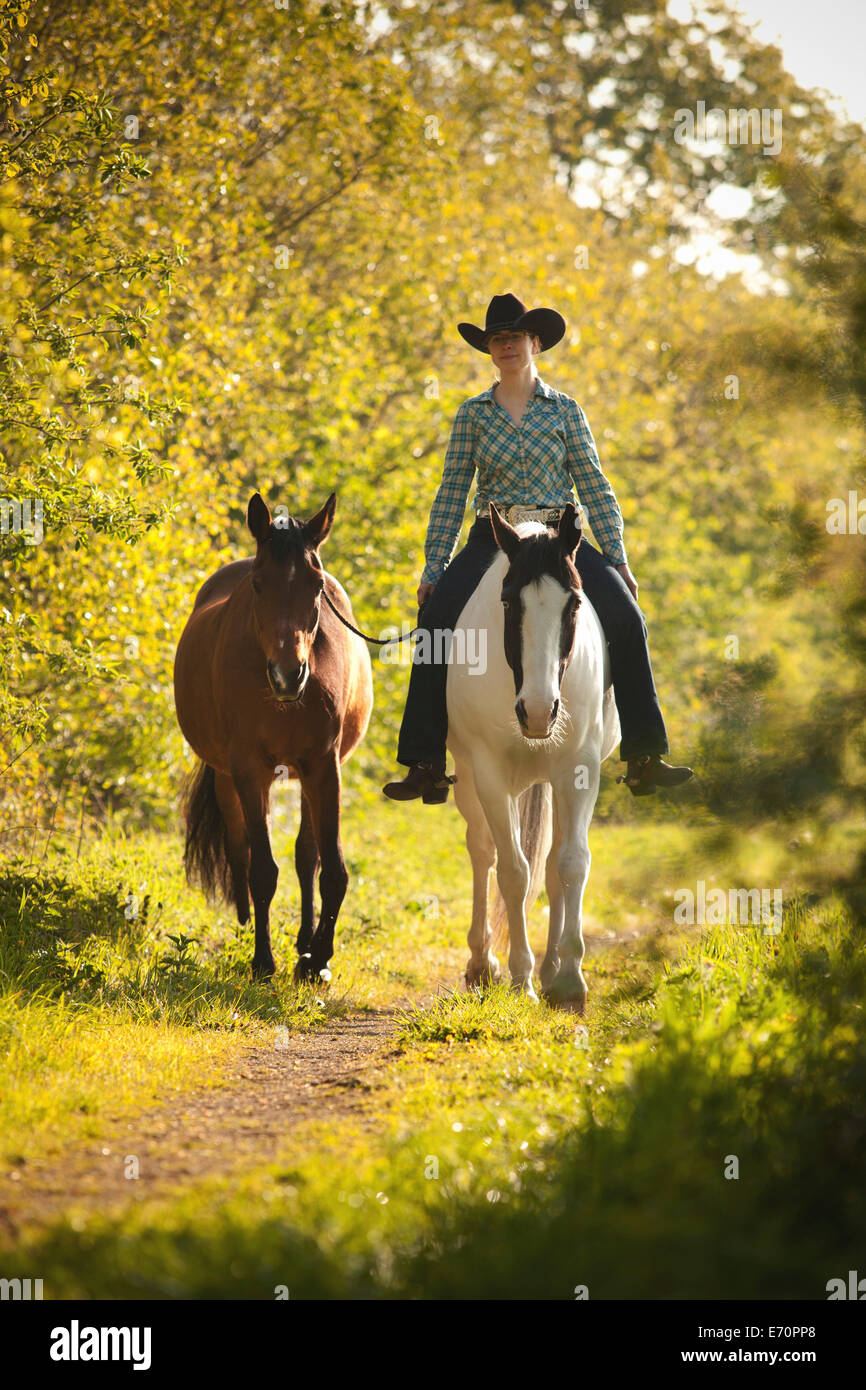 Female western rider on a Paint Horse, Black Tobiano colour pattern