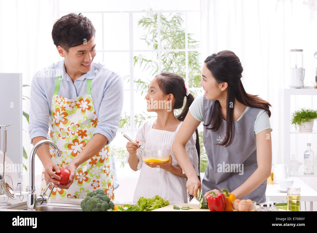 Family cooking in kitchen Stock Photo - Alamy