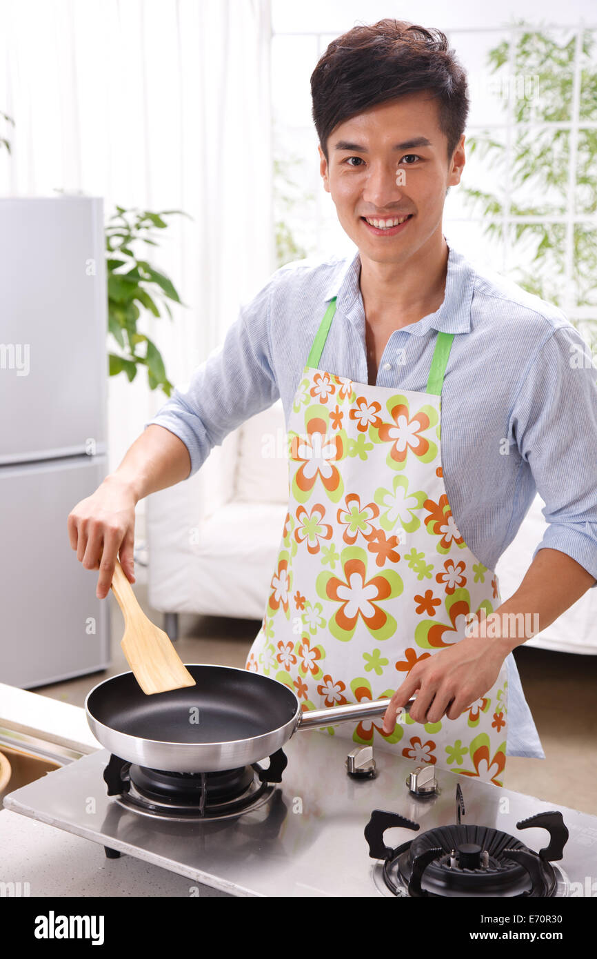 Man Cooking In Kitchen Young man cooking in kitchen Stock Photo - Alamy