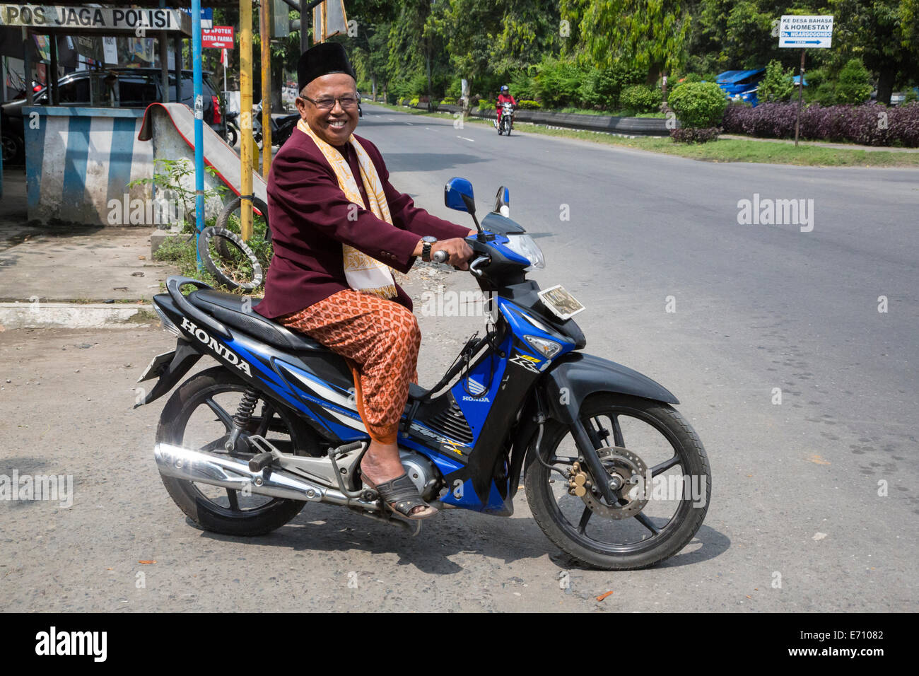 Borobudur, Java, Indonesia.  Imam from Neighborhood Mosque Going Home after Friday Noon Prayers. Stock Photo