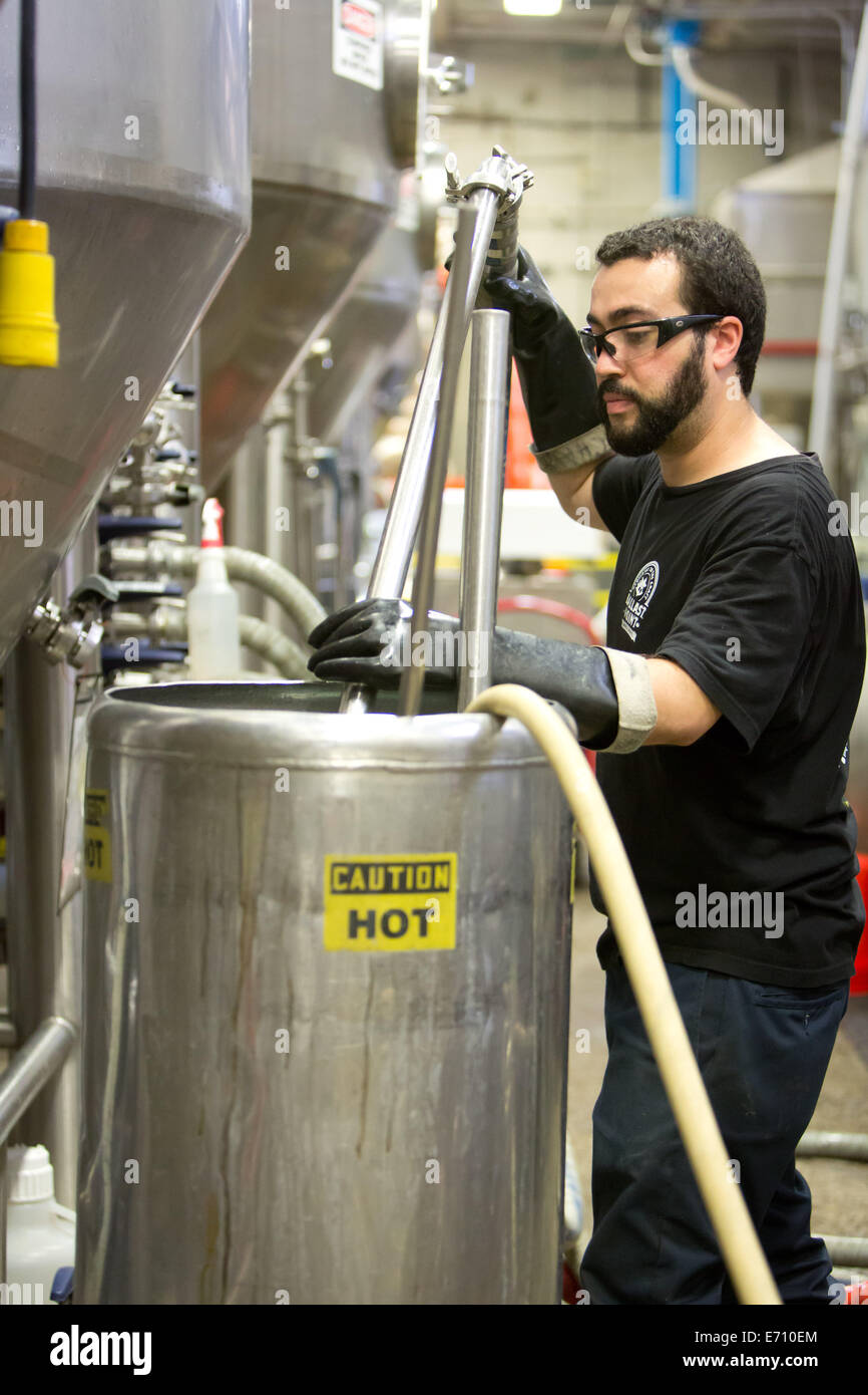 Andrew is cleaning the kegging line with iodine and water at the